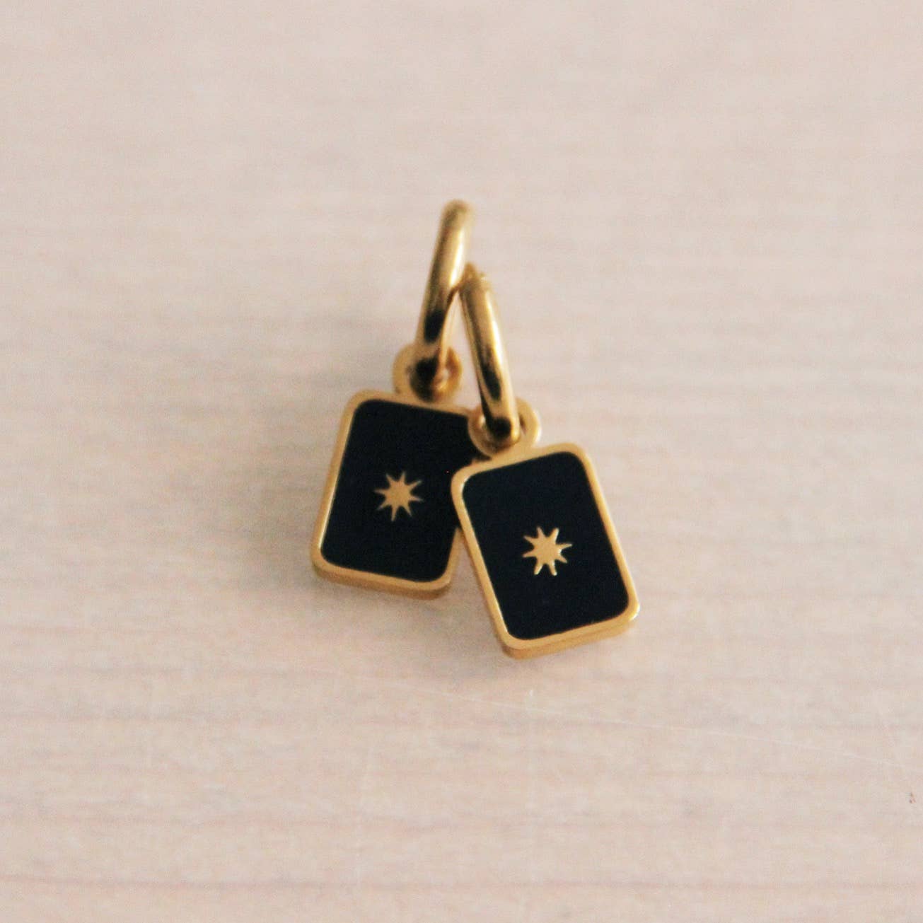 Bazou earrings with black square star tag